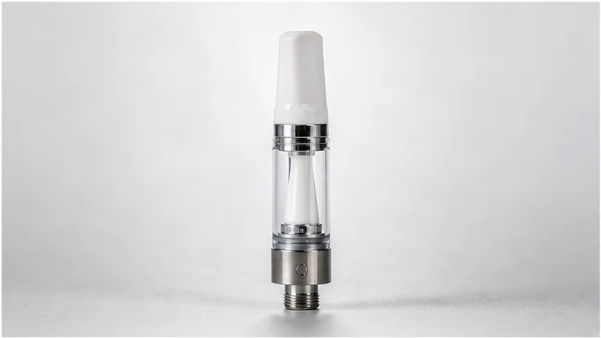 Ceramic core vape cartridge on a clean neutral background