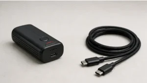 Compact device beside a USB-C charging cable