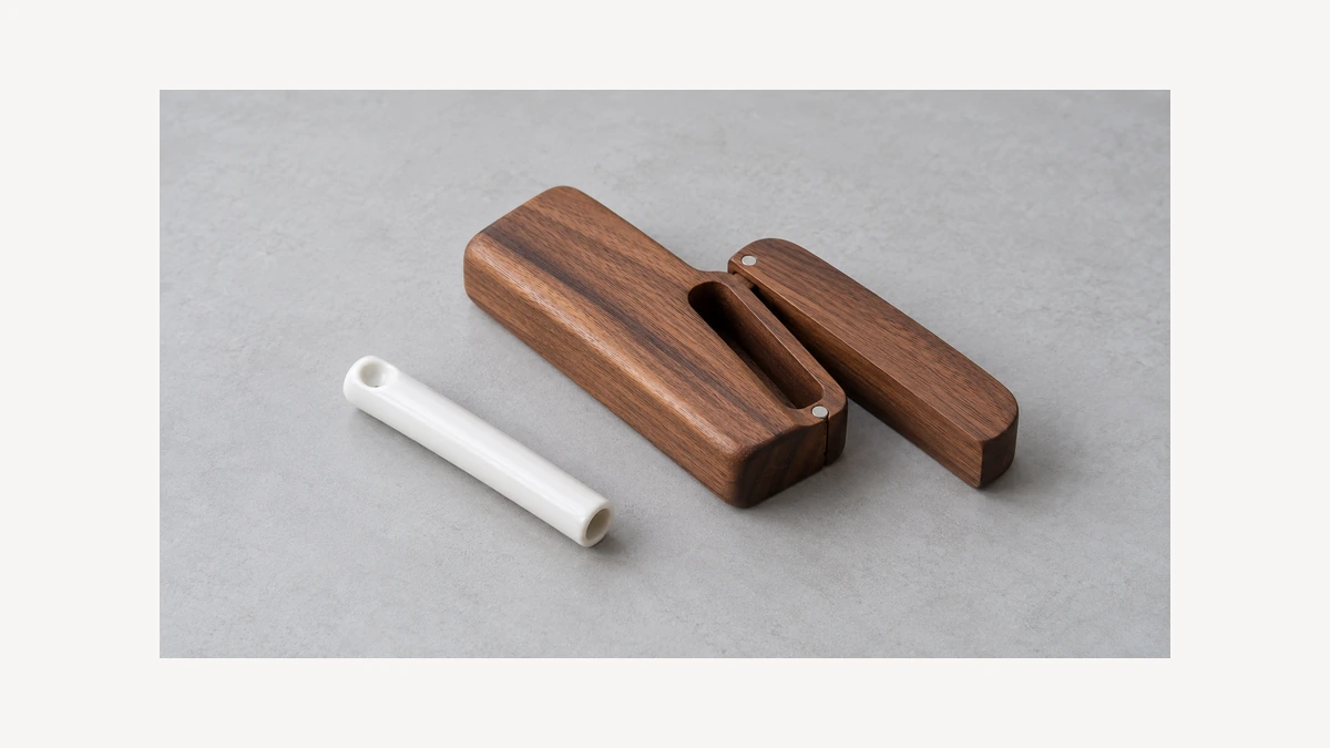 Ceramic tube beside open empty wooden storage case