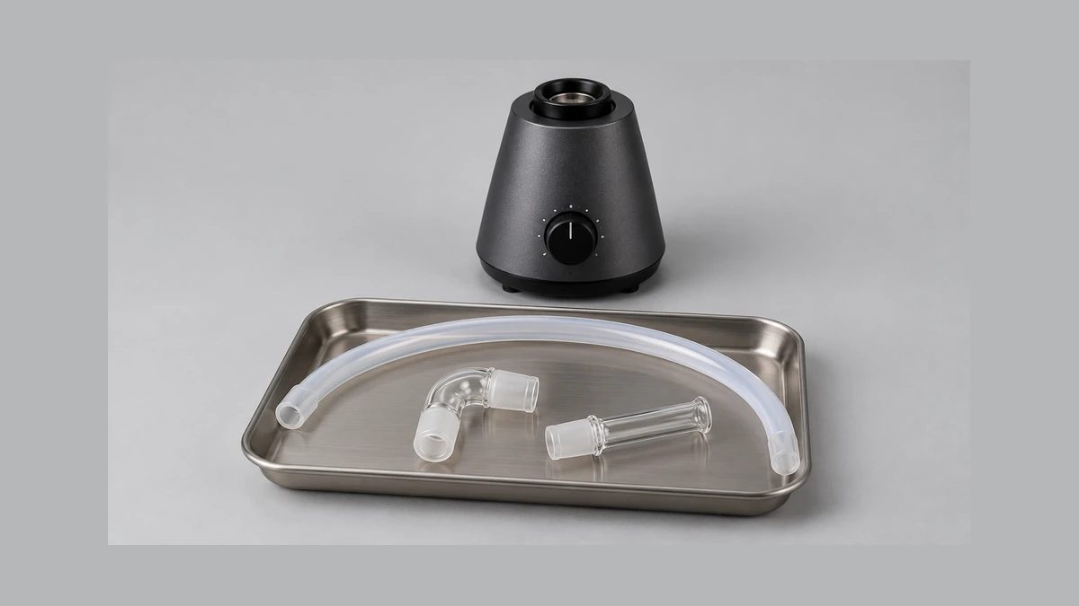 Detached flexible whip tube and separate glass fittings on a shallow tray Detached flexible whip tube and separate glass fittings on a shallow tray