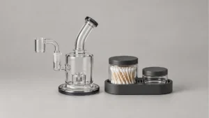 Empty compact dab rig beside separate closed swab jar and empty lidded cleaning well