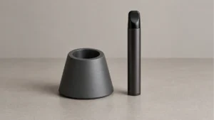 Empty cup style passive holder beside a powered off solid body wax pen