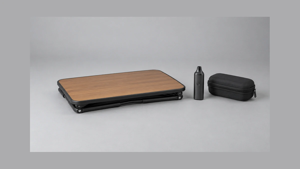 Empty folded tray table beside a closed accessory case and vaporizer