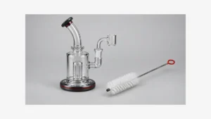 Empty glass rig beside a separate long cleaning brush