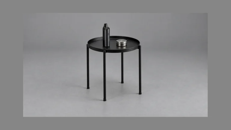 Freestanding raised edge side table with vaporizer and closed parts tin