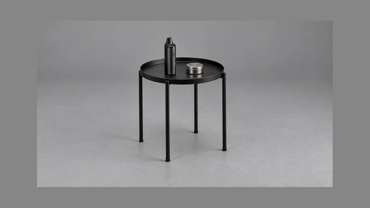 Freestanding raised edge side table with vaporizer and closed parts tin