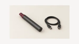 Opaque vaporizer pen with visible USB-C socket beside a disconnected cable
