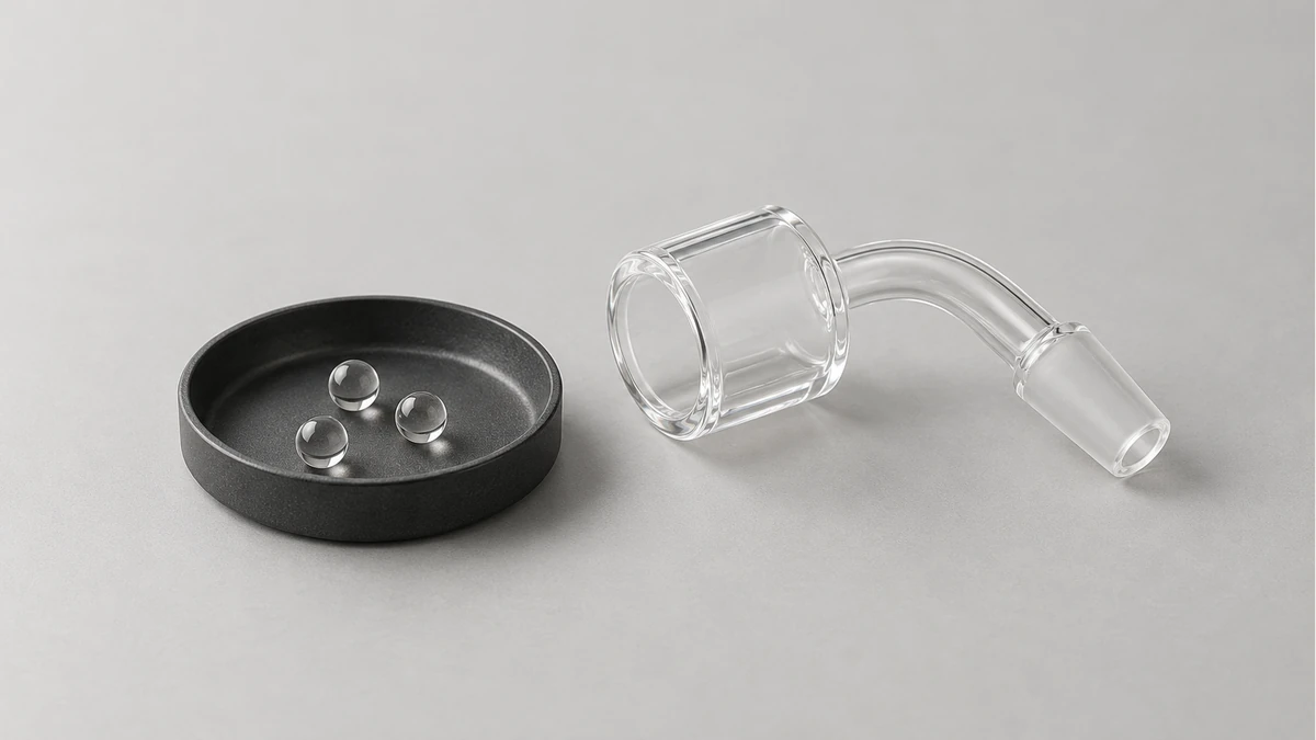 Small clear spherical accessories in a tray beside an empty banger Small clear spherical accessories in a tray beside an empty banger