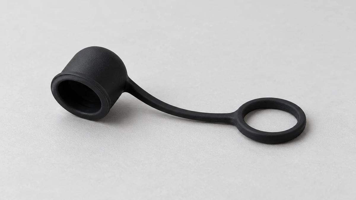 Soft silicone mouthpiece cap and tether shown separately from a compact vaporizer