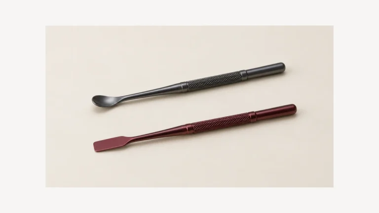 Two empty accessory tools with curved scoop and flat spatula ends