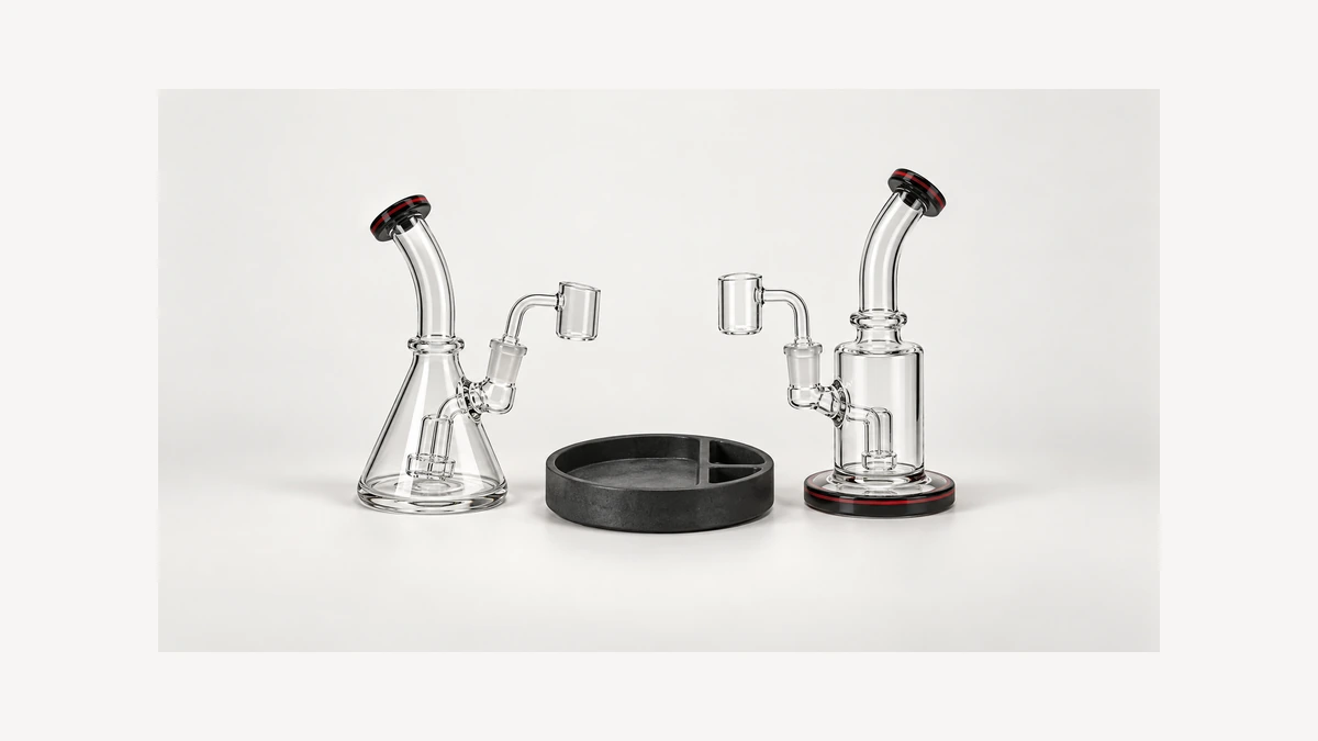 Two empty glass rig base shapes beside a support tray