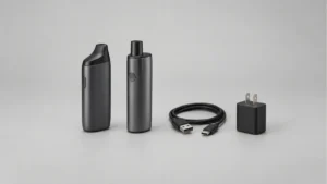Two powered off solid body vaporizers beside disconnected cable and unplugged power supply